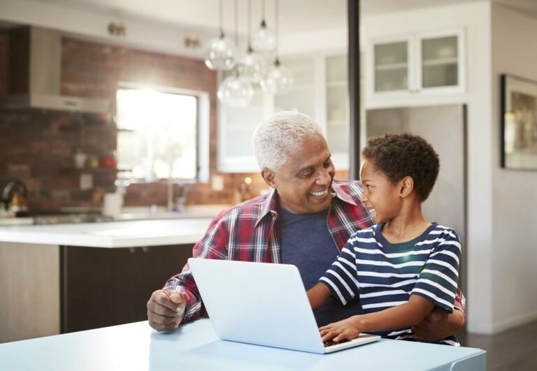 The Philomena | Senior using computer with grandson