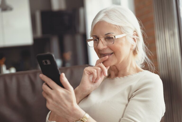 The Philomena | Seniors woman looking at smartphone