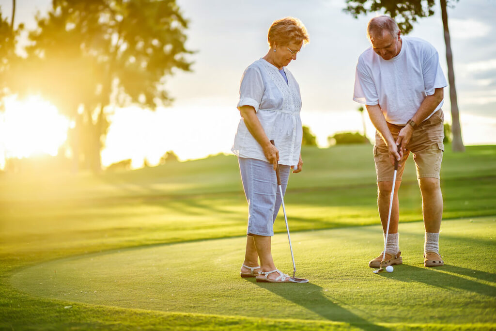 The Philomena | Seniors practicing their putting on the putting green