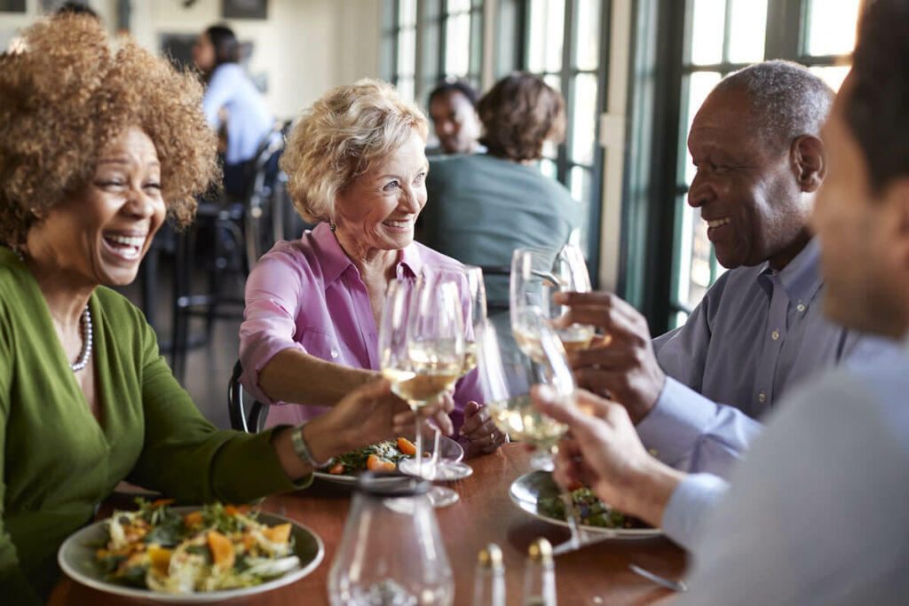 The Philomena | Group of happy seniors out to dinner