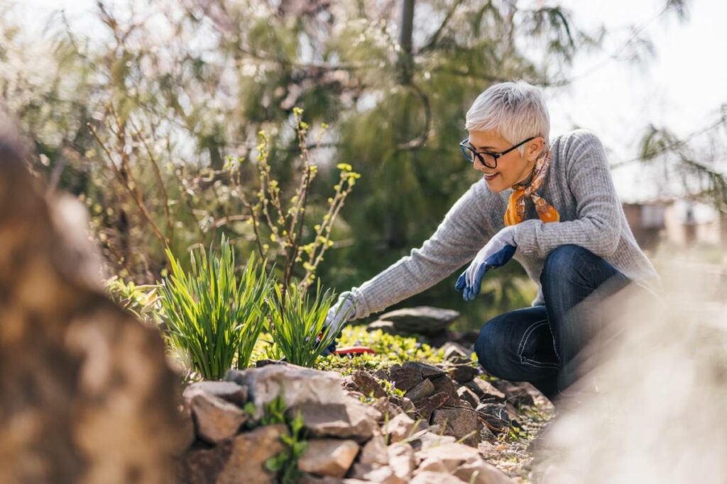 Philomena | Happy senior woman working in a garden