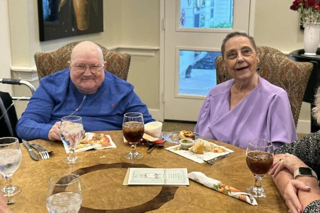 The Philomena | Senior couple sitting for dinner during their 50th wedding anniversary celebration